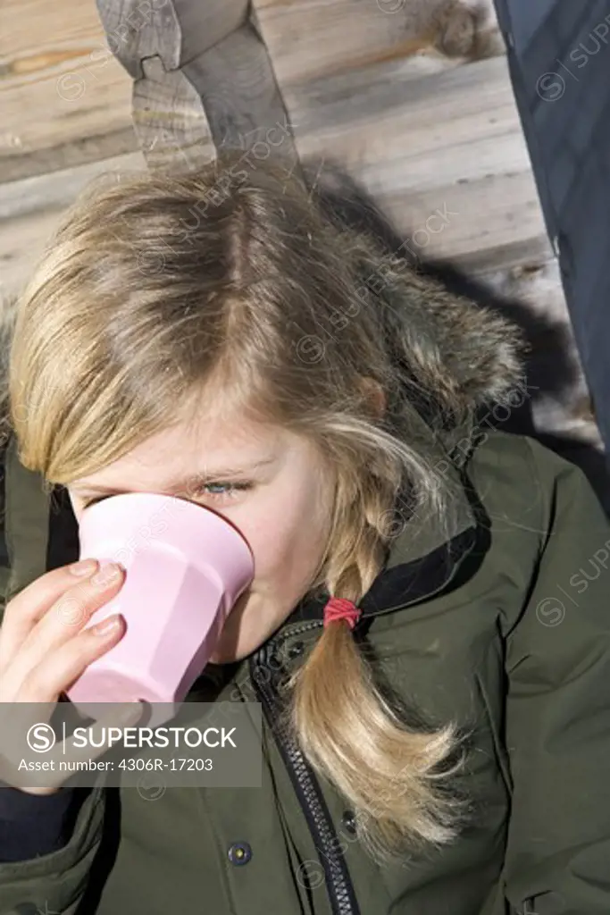 A girl having a break during a skiing day, Sweden.