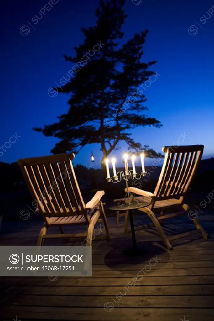 Candle lights on a terrace at dusk, Sweden.