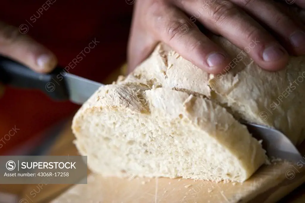 A man slicing bread, Sweden.