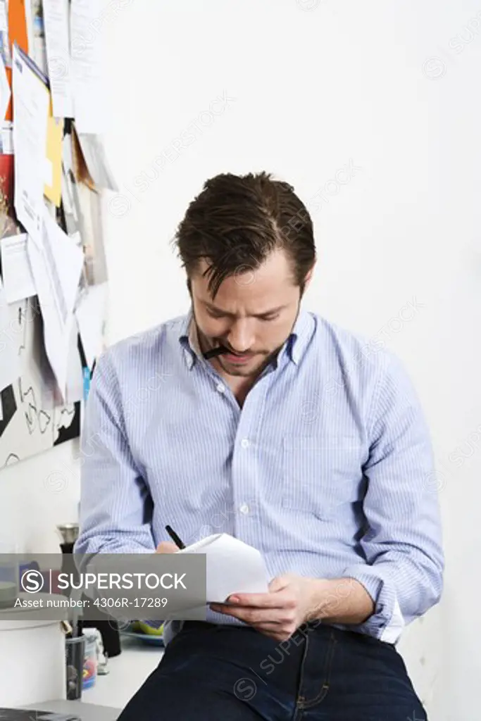 A man reading a document, Sweden.