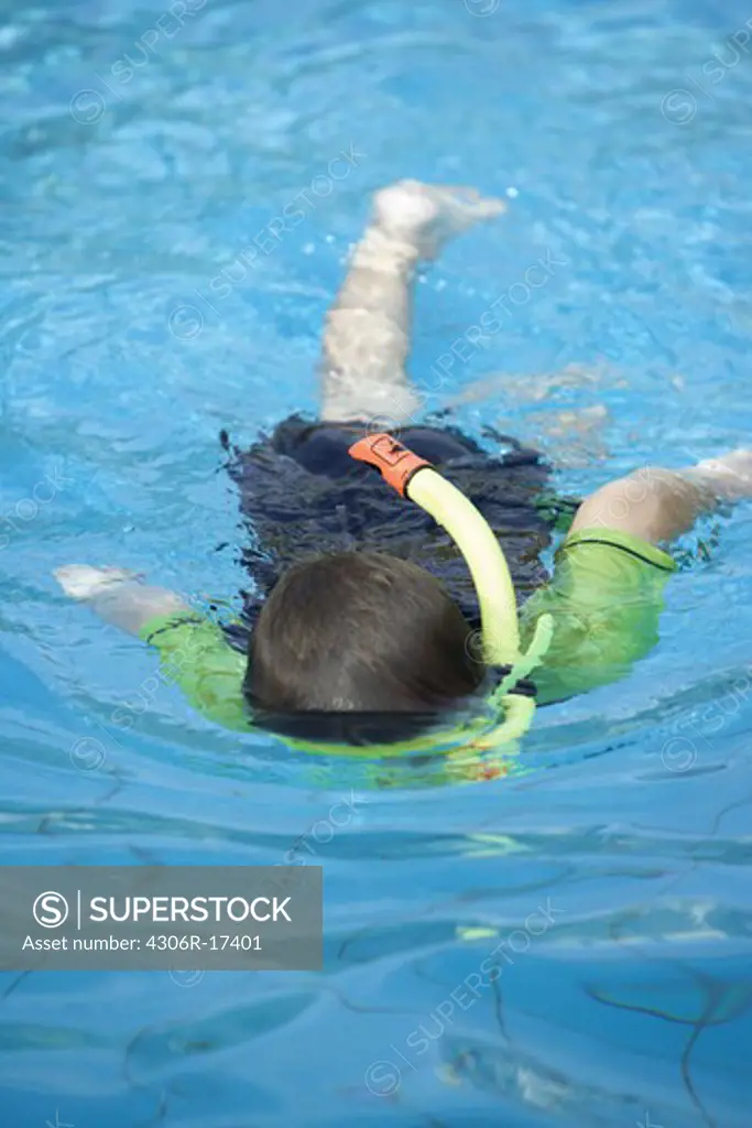 A boy in a swimming-pool.