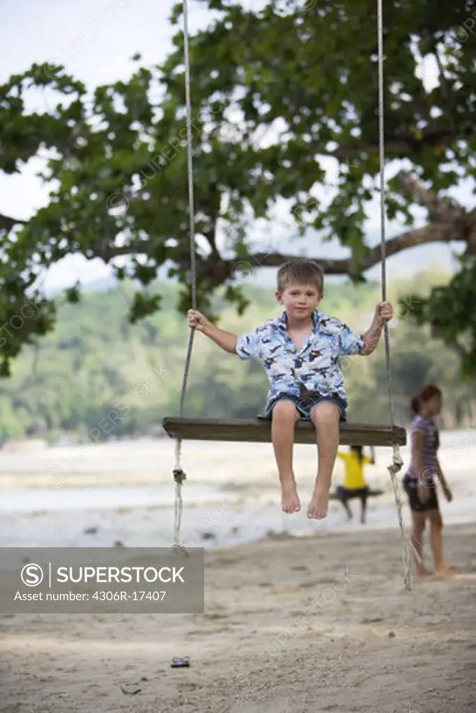 A boy on a swing.