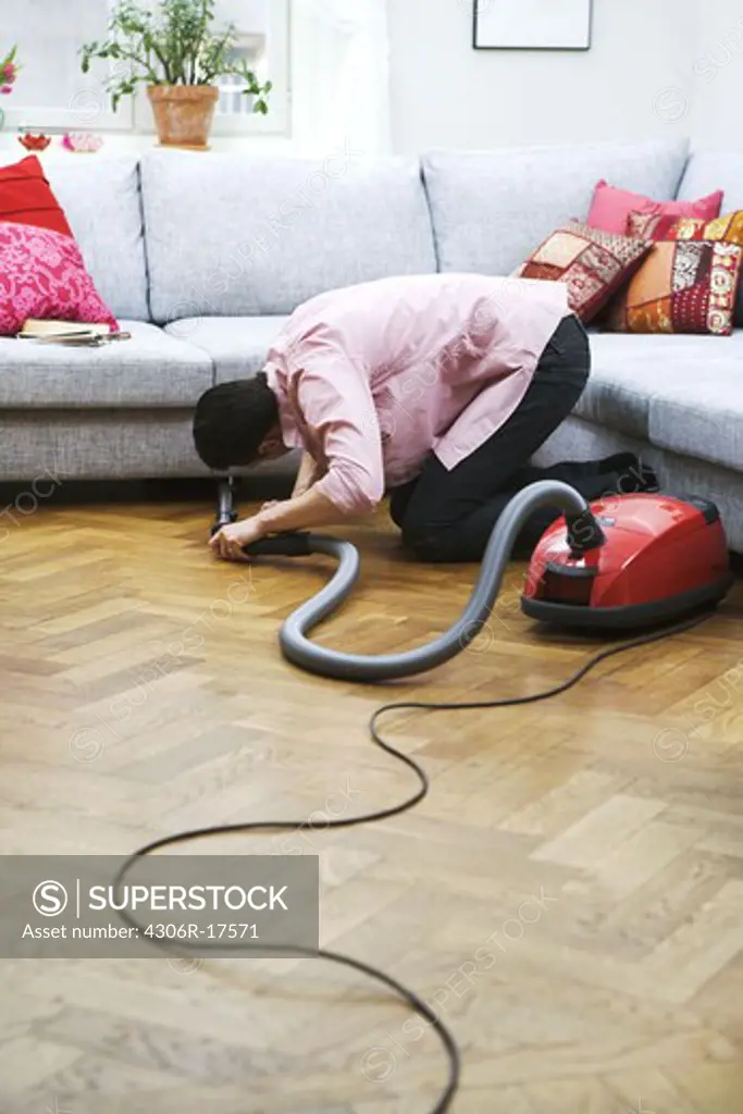 A man vacuuming, Sweden.