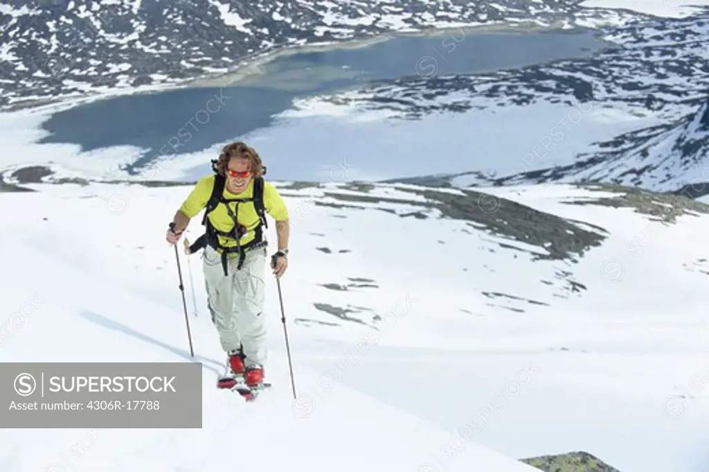Man telemark skiing in mountain scenery