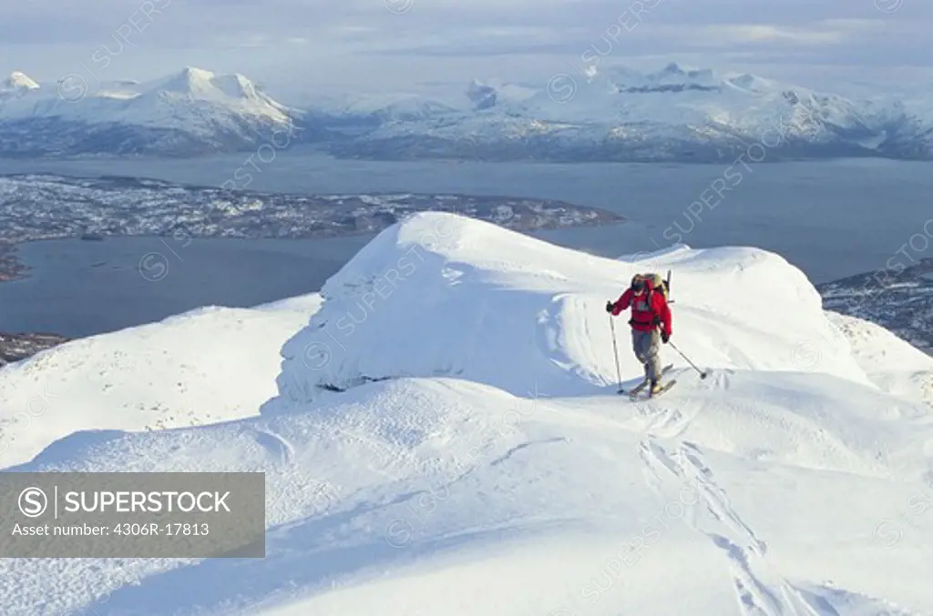 Person telemark skiing in mountain scenery