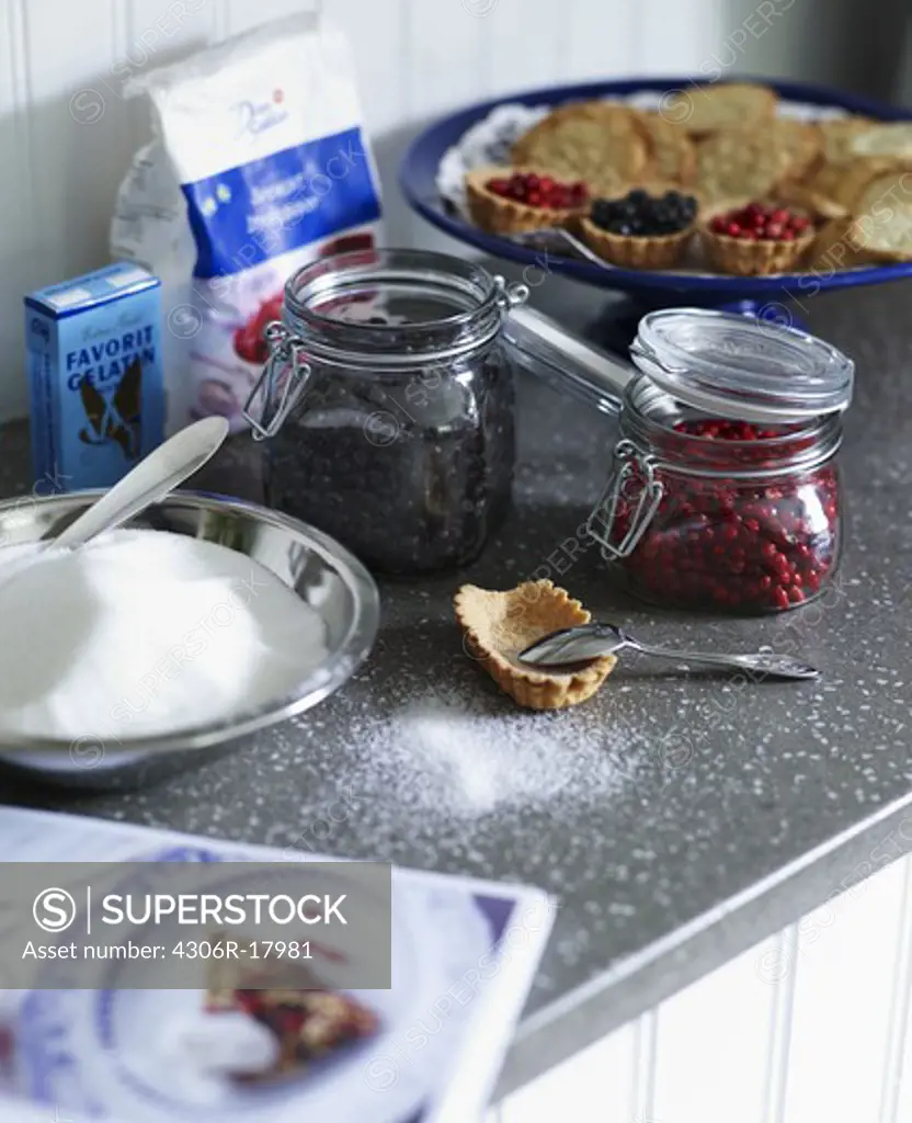 Lingonberry, cookies and bilberry on a worktop, Sweden.