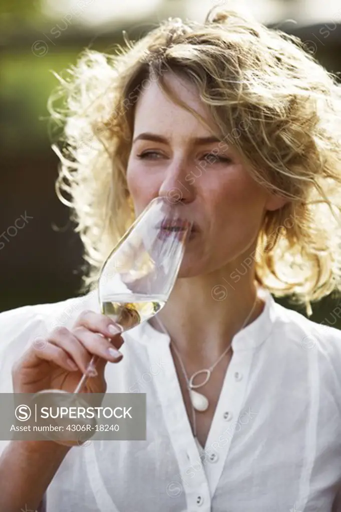 A woman having a glass of champagne, Copenhagen, Denmark.