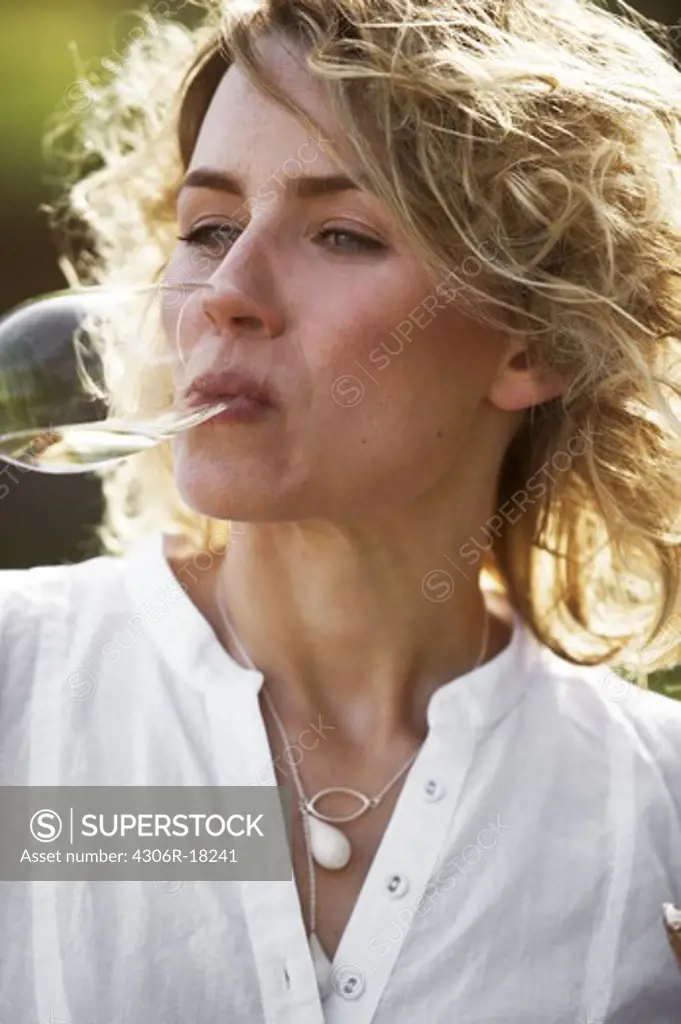 A woman having a glass of champagne, Copenhagen, Denmark.