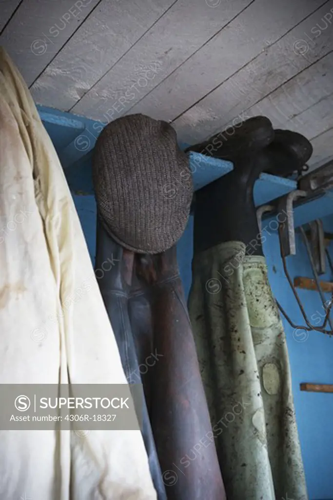 Fishing clothes in a boathouse.