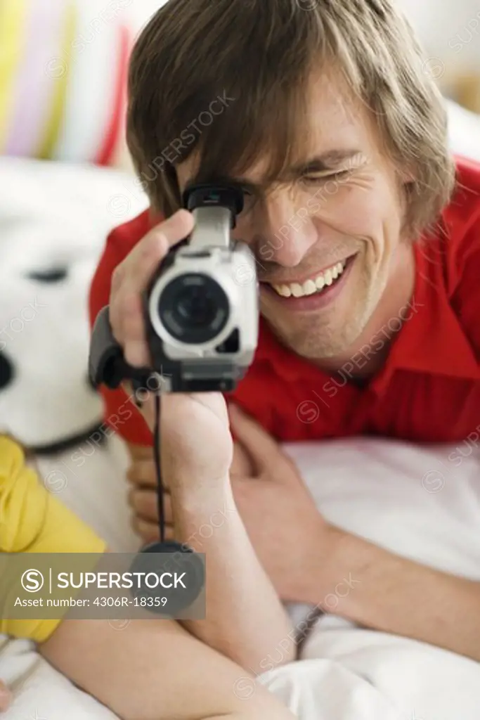 A young couple with a video camera.