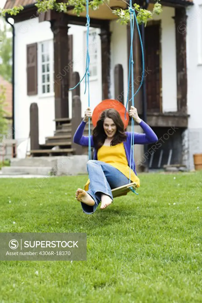 A Scandinavian woman on a swing.