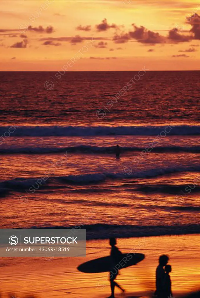 Surfer in the sunset, Bali.
