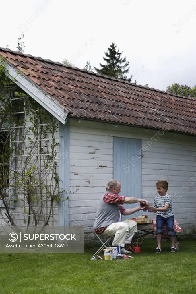 Grandfather and grandson at the summer cottage, Sweden.
