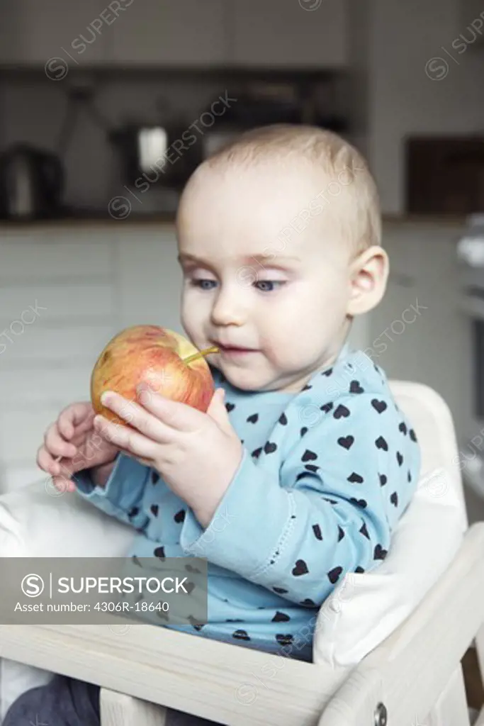 A girl having an apple, Sweden.
