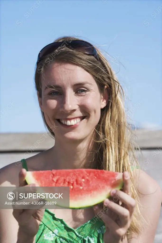 A woman having a water melon, Sweden.