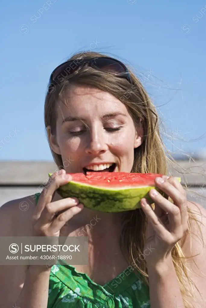 A woman having a water melon, Sweden.
