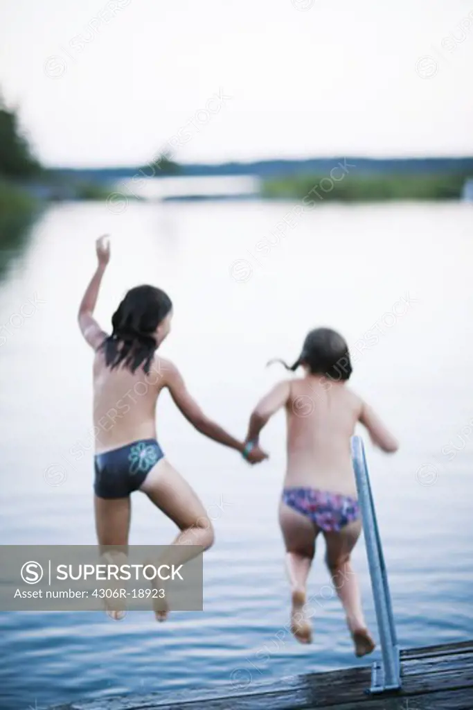 Two girls on a jetty, Sweden.