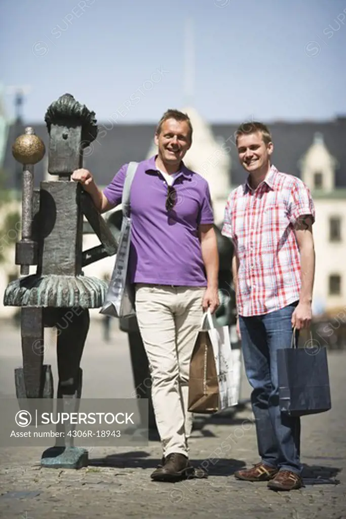 Two men with shopping bags in Malmo, Sweden.