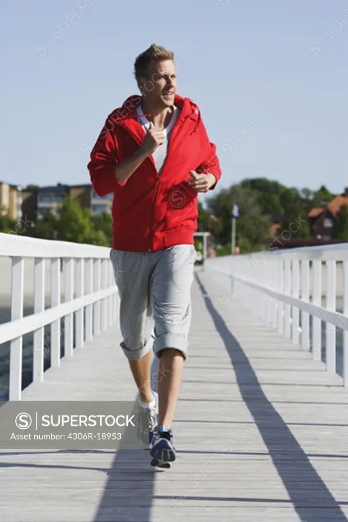 A man jogging on a jetty, Malmo, Sweden.