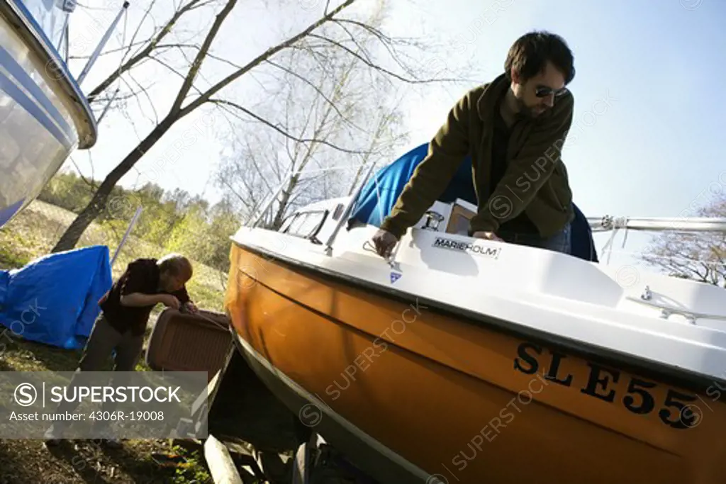 Two men and a sailing-boat, Sweden.