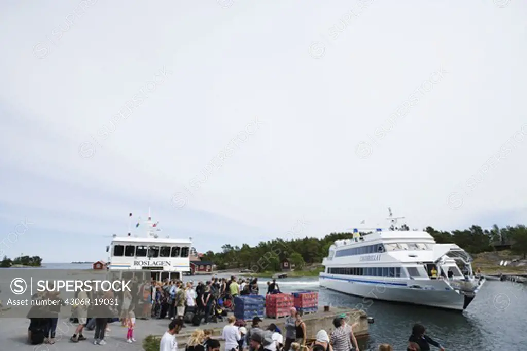 People waiting for a boat in the archipelago, Sweden.