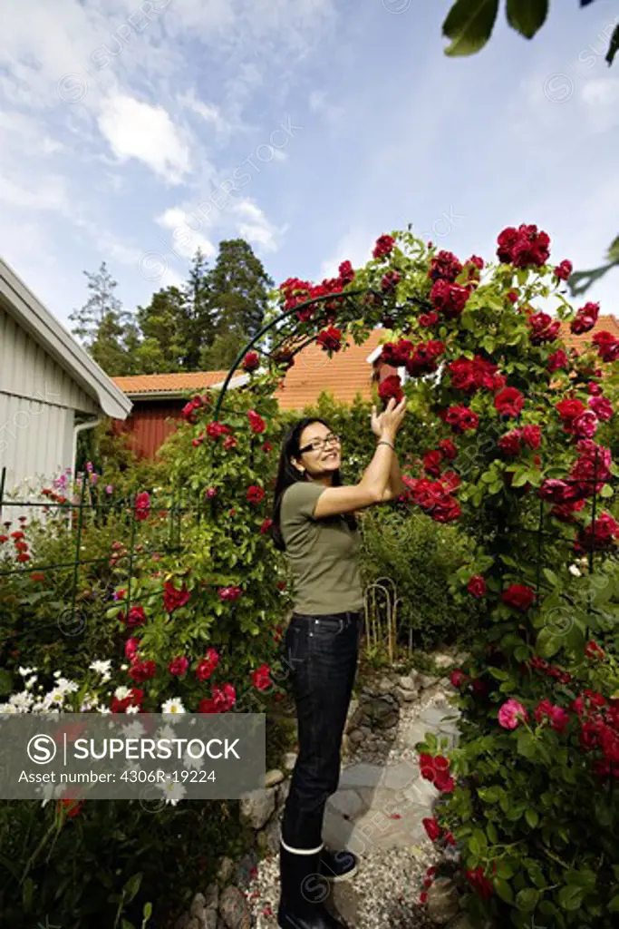 A Japanese woman in her Swedish garden, Sweden.