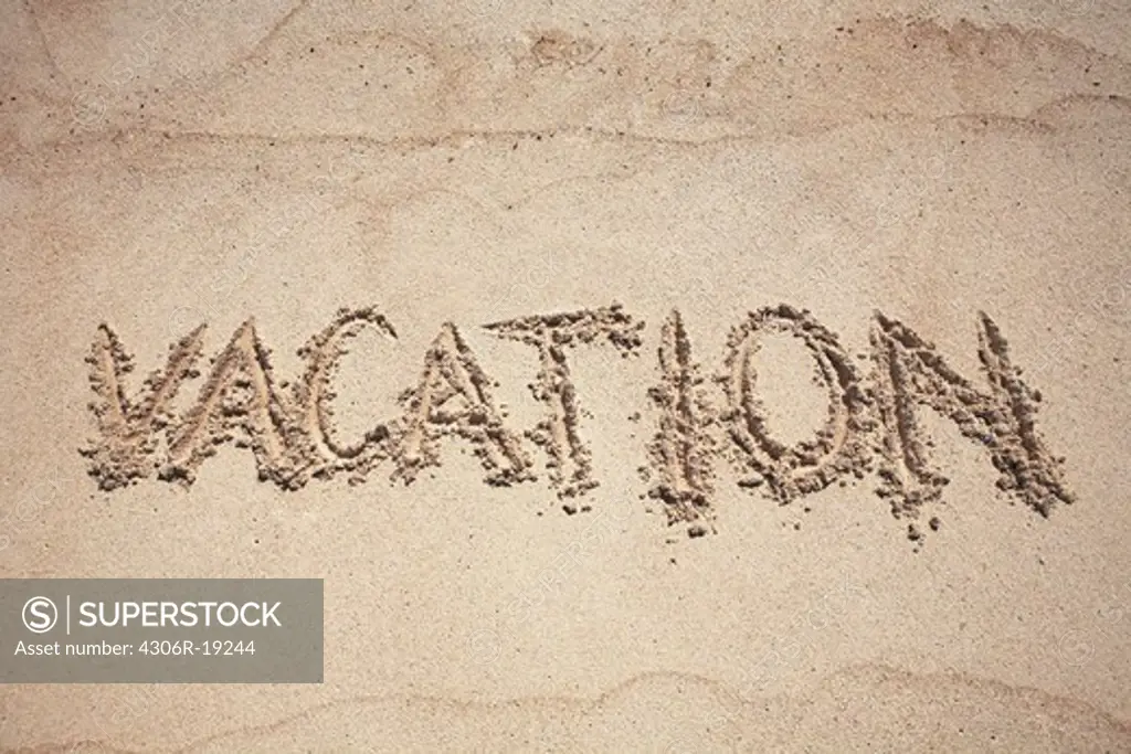 Text vacation on sand