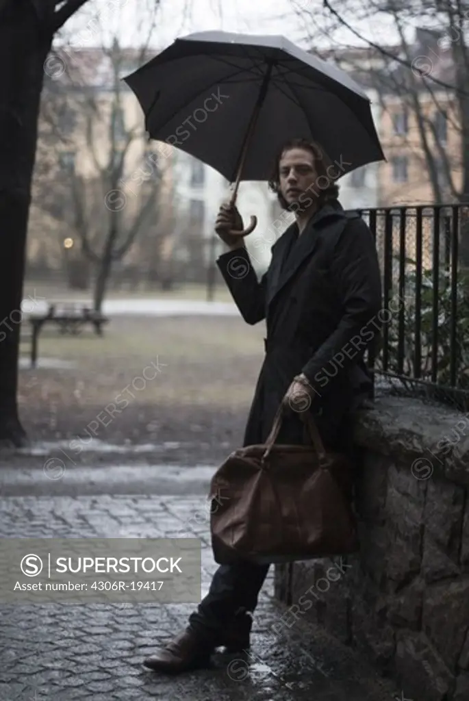 A man holding an umbrella, Sweden.