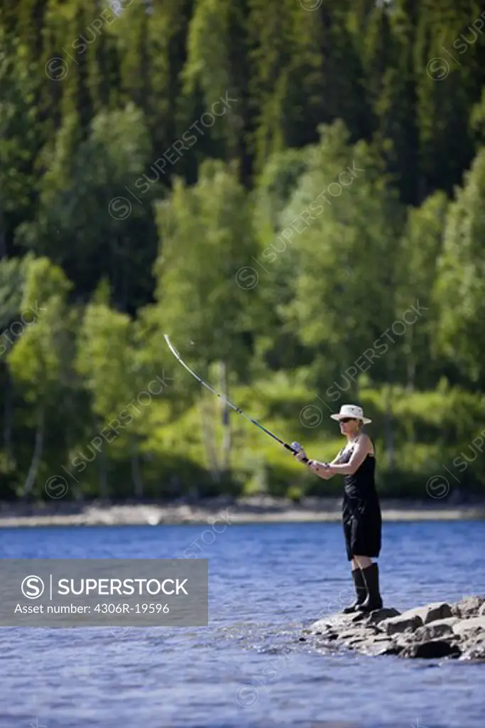 A woman fishing, Jamtland, Sweden.