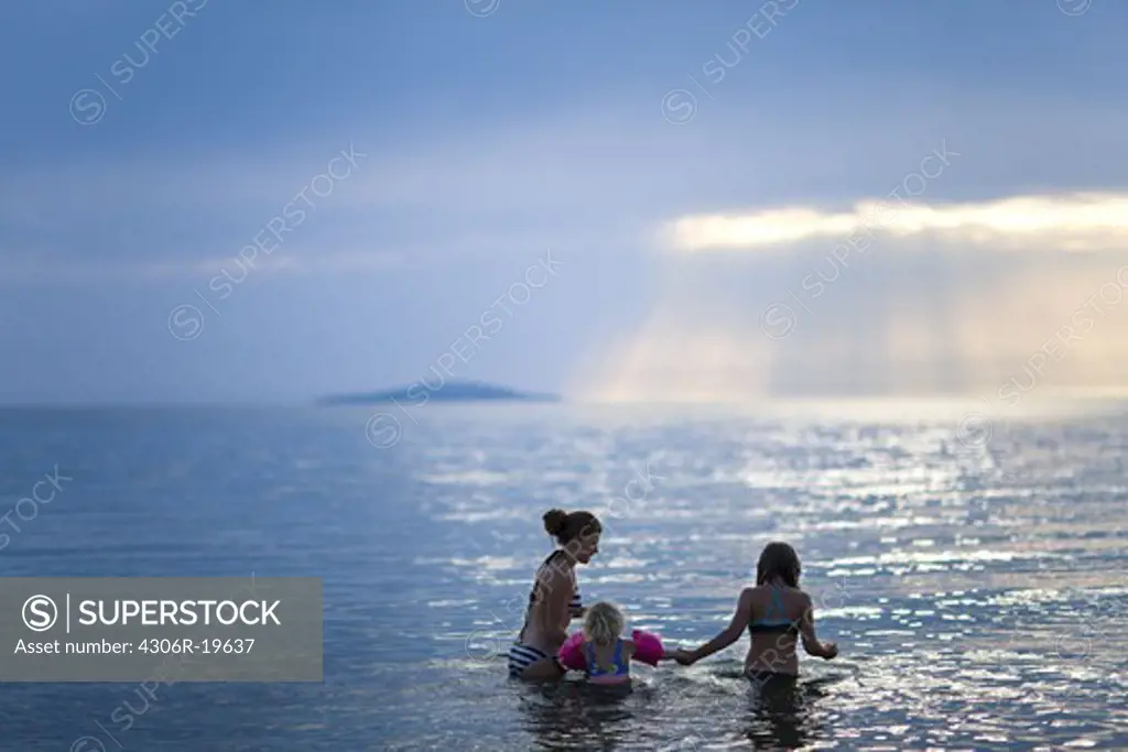 Girls bathing in the sea, Sweden.