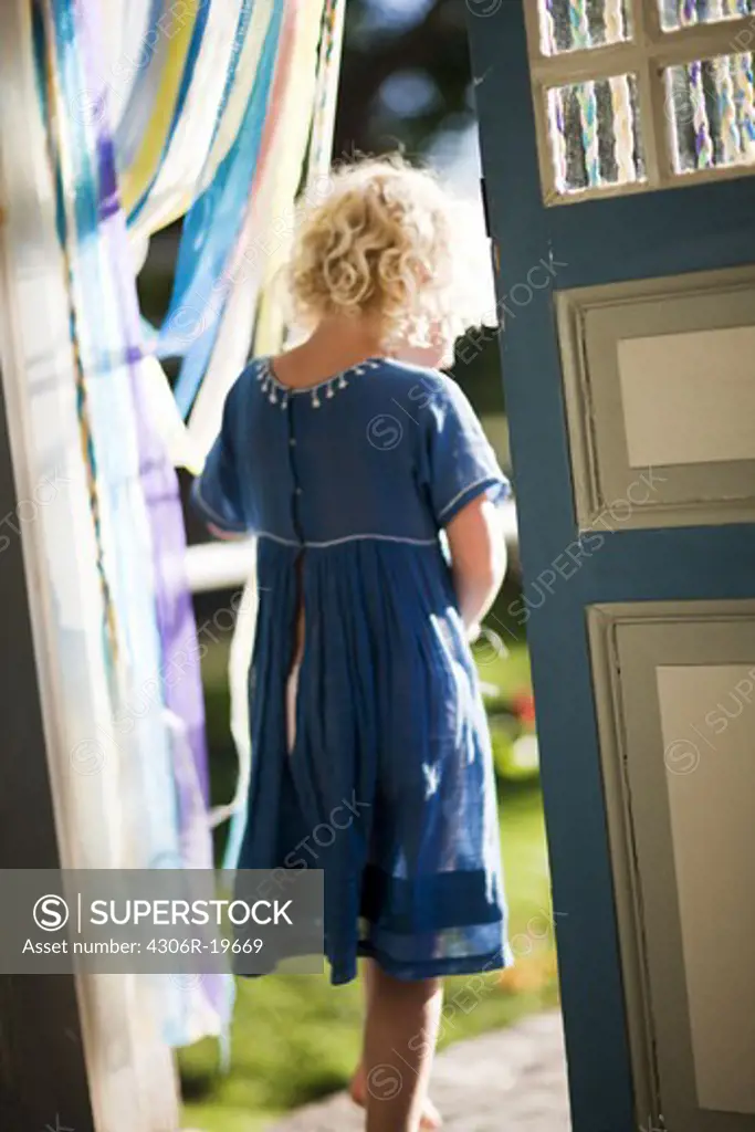 A girl passing through a doorway, Sweden.