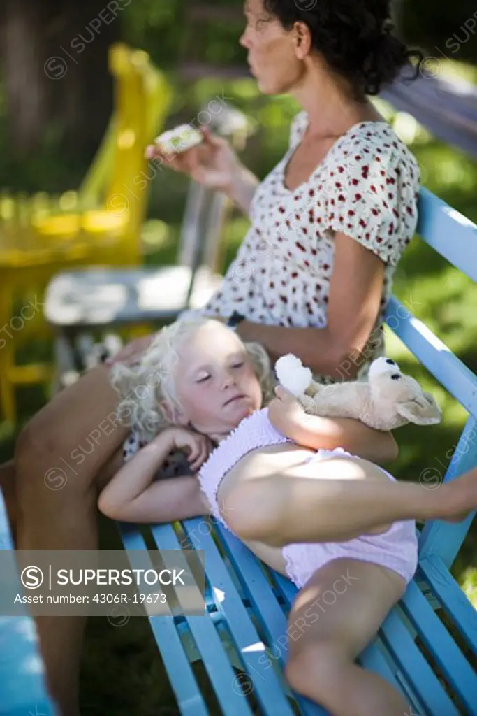 Mother and daughter on a garden seat, Sweden.
