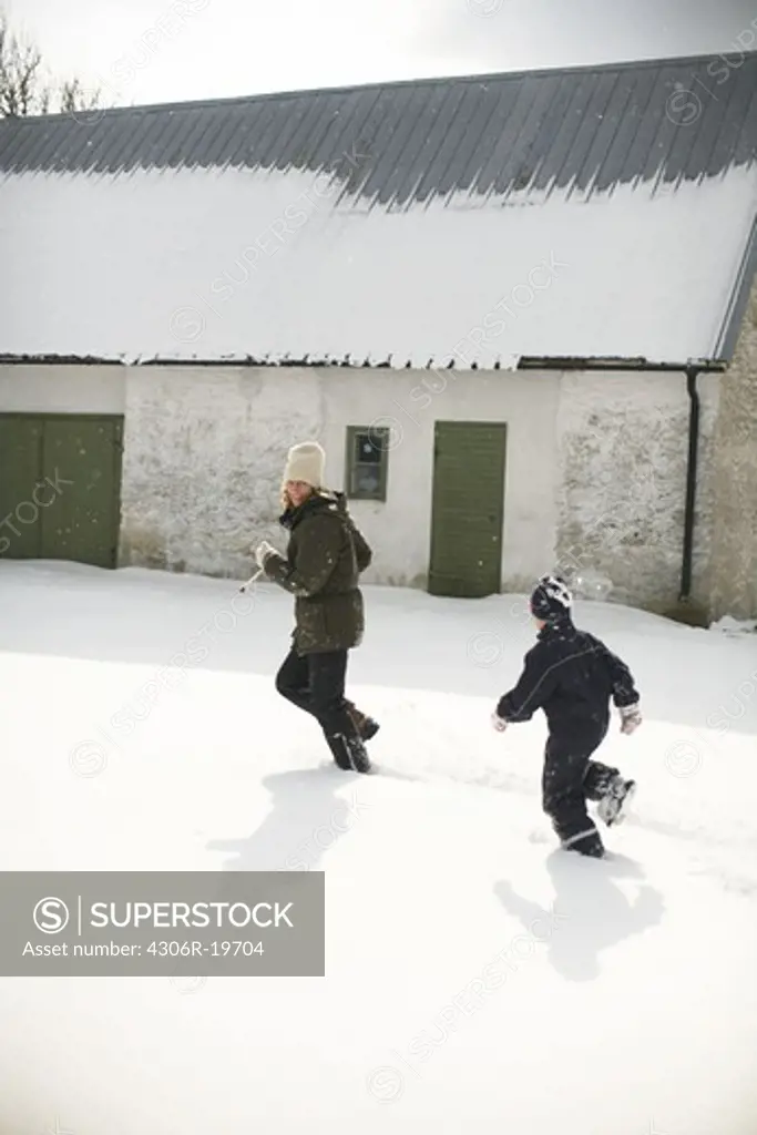 Mother and boy playing in the snow, Gotland, Sweden.