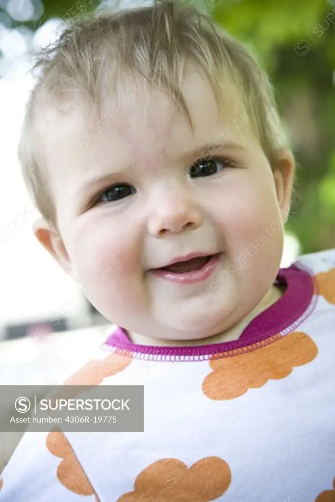 A smiling baby wearing a patterned t-shirt, Sweden.