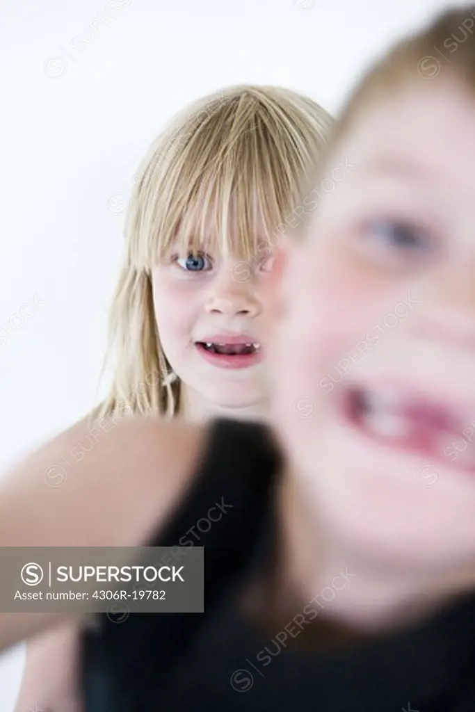 Two children looking into the camera, Sweden.