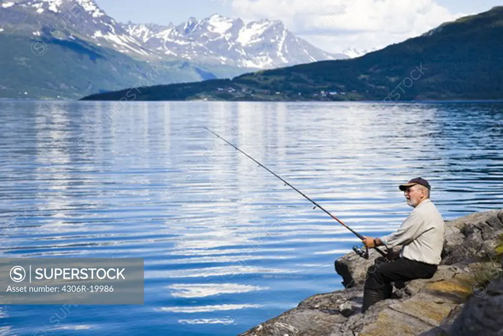 Man fishing in the fiord, Gratangen, Norway.