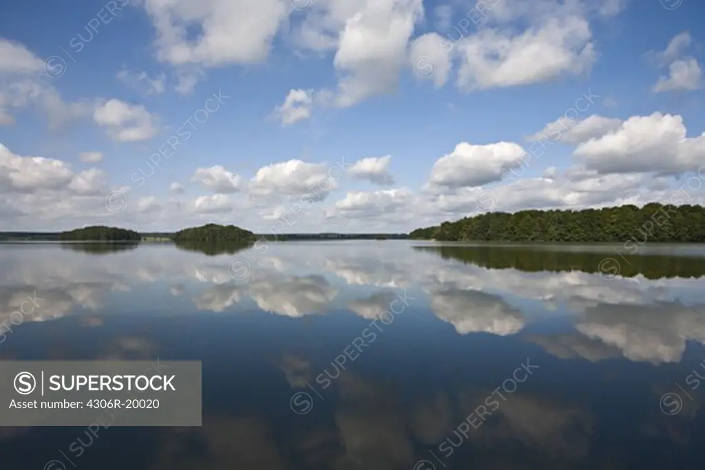 Clouds reflected on the surface of a lake, Sweden.