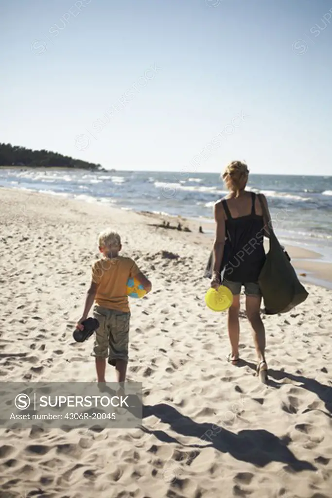 Mother and son walking on the beach, Gotland, Sweden.