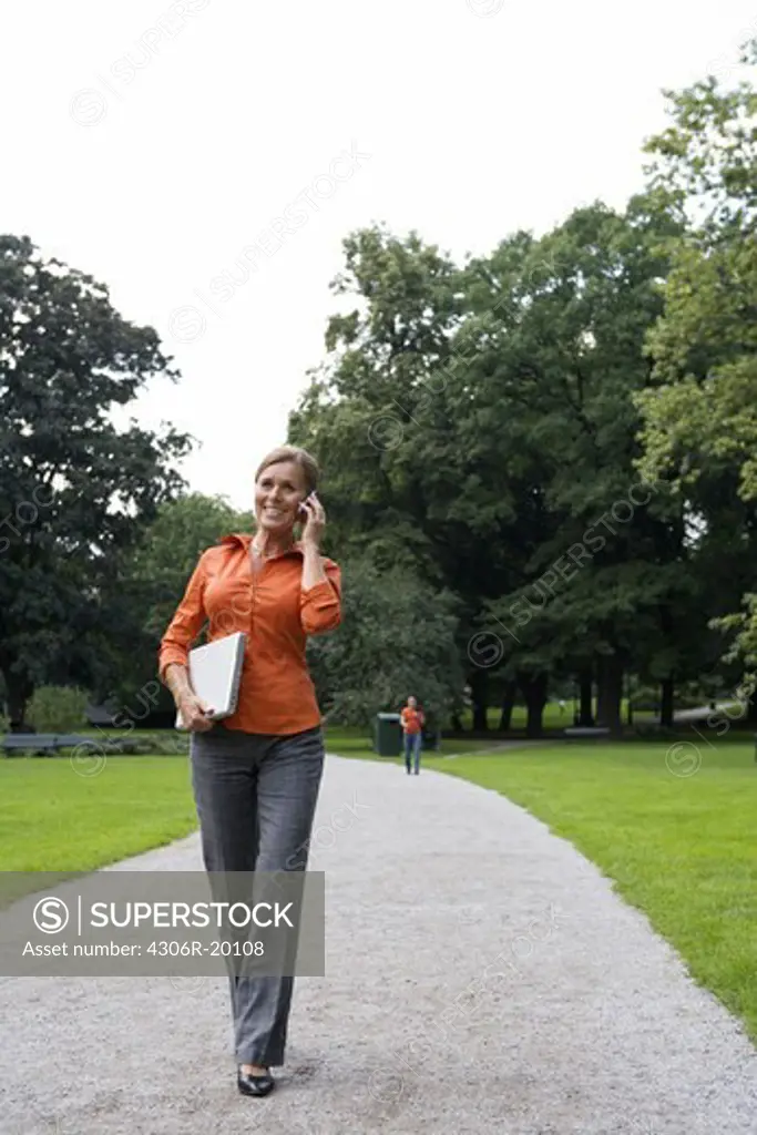 A woman in a park using a laptop, Stockholm, Sweden.