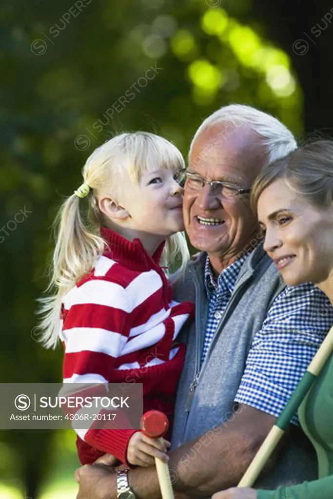 Senior man, girl and woman in the park, Sweden.