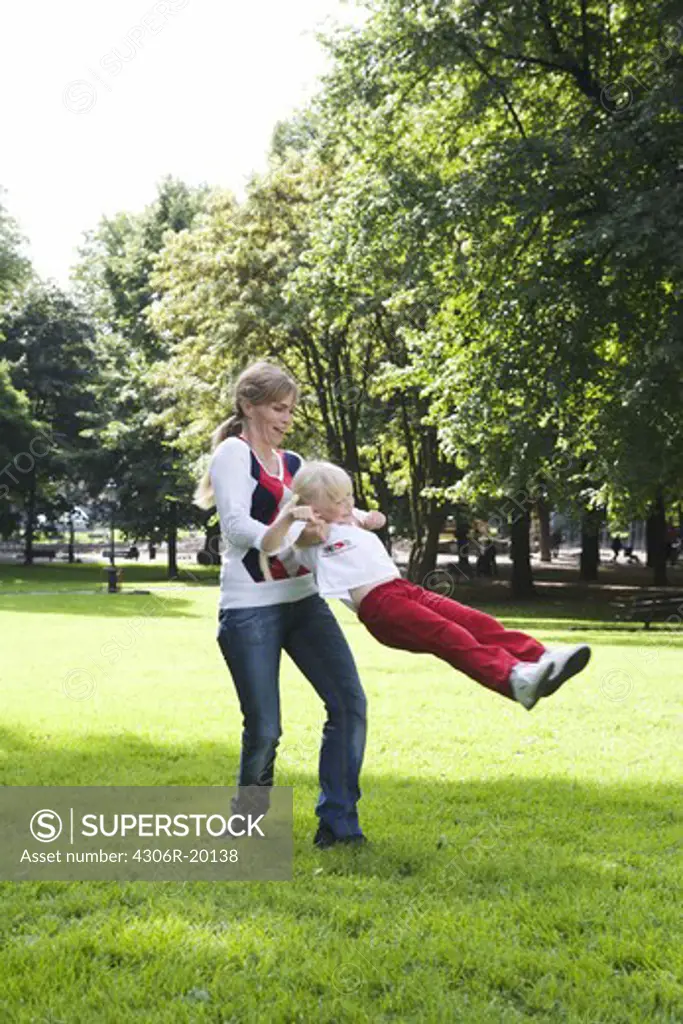 Woman and girl playing in the park, Sweden.