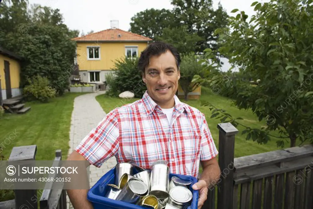 A man recycling aluminium cans, Sweden.