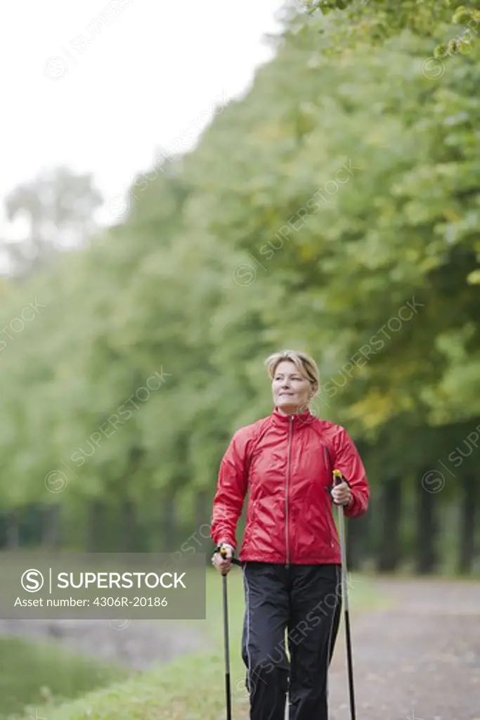 A woman walking in a park.
