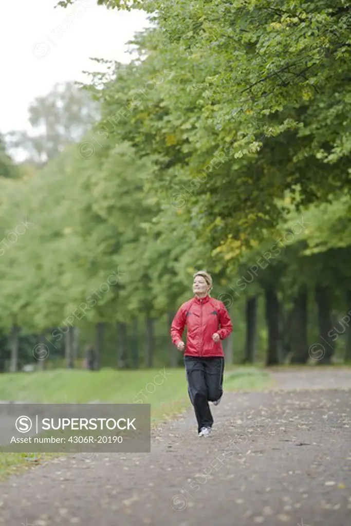 A woman jogging in a park, Sweden.