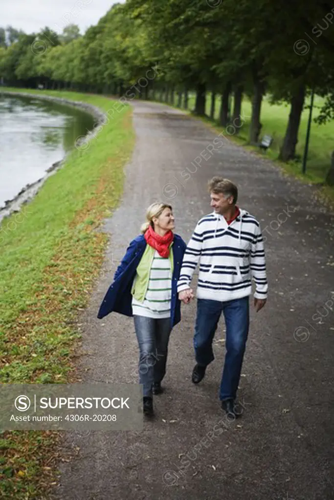 A tender couple strolling in the park, Sweden.