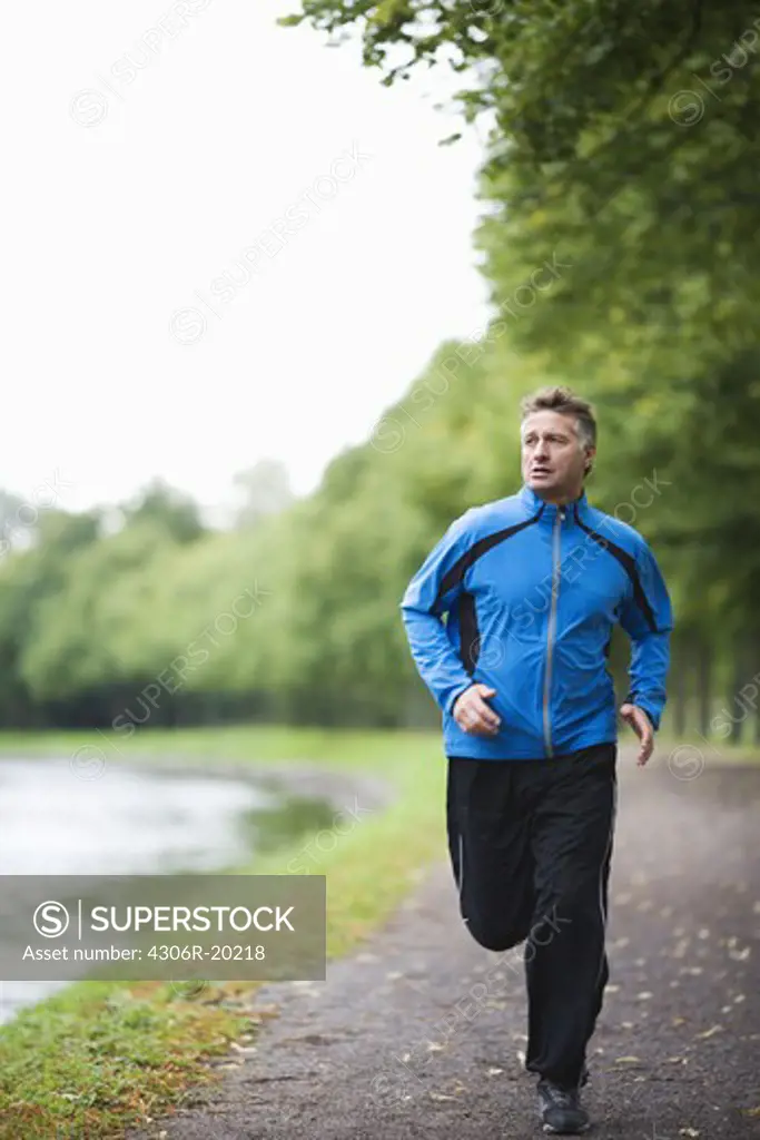 A man jogging in a park, Sweden.