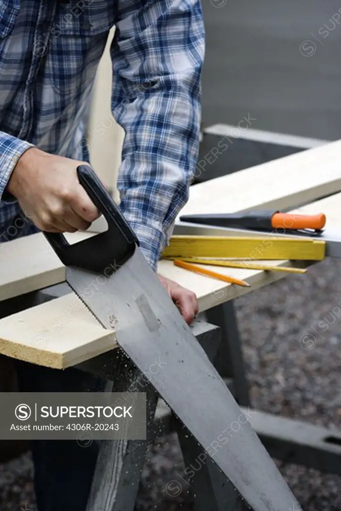A man using a saw, Sweden.