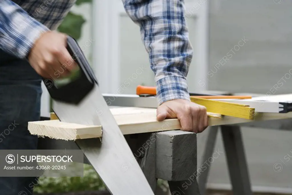 A man using a saw, Sweden.