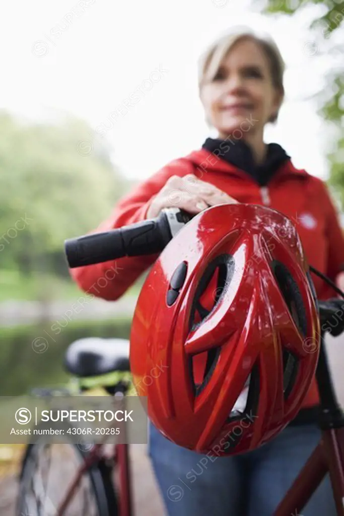 A woman, a bicycle and a safety helmet, Sweden.