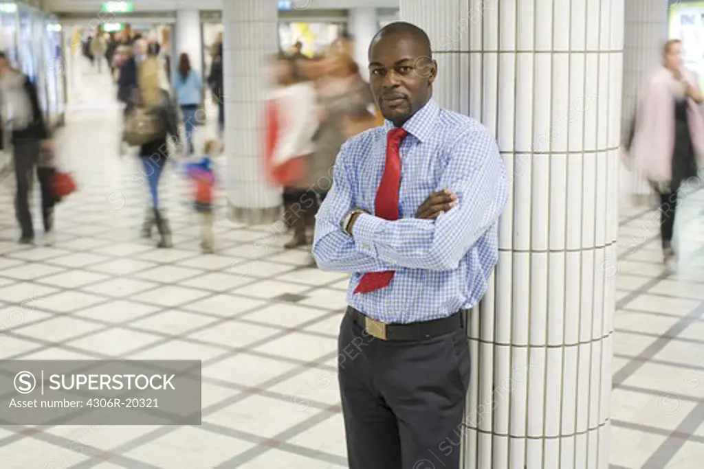 A businessman at a train station, Stockholm, Sweden.